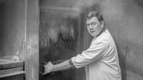 Hugh Maguire owner of The Smokin' Butcher brand removing his smoked black pudding from the smoker